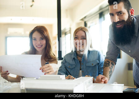 Casually dressed architects smiling in office Stock Photo