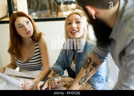 Colleagues discussing project in casual office Stock Photo