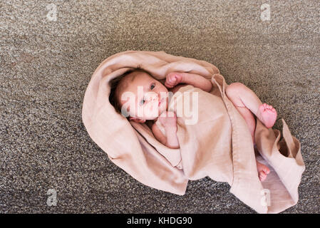 New born baby wrapped in towel Stock Photo