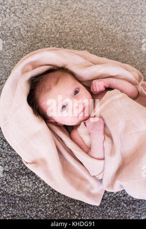 New born baby wrapped in towel Stock Photo