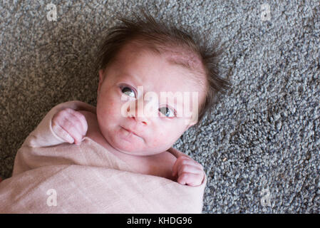 New born baby wrapped in towel Stock Photo