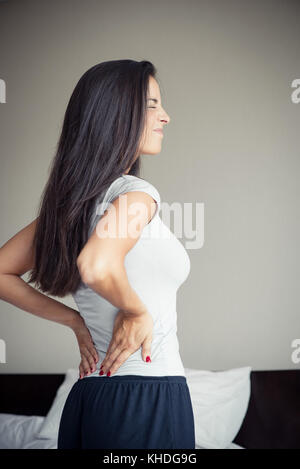 Woman suffering from back pain Stock Photo