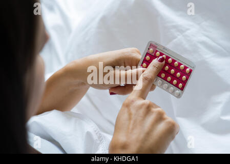 Woman holding birth control pills Stock Photo