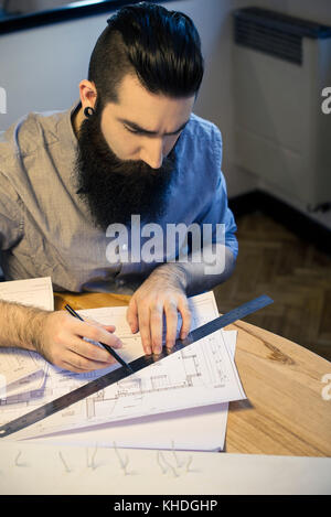 Architect working with blueprints in office Stock Photo