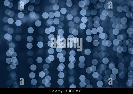blue  cold christmas holiday background with blurred festive lights Stock Photo