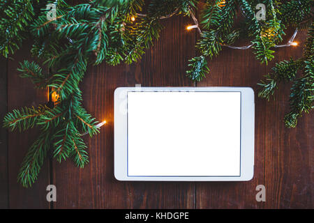 digital tablet computer on christmas festive background, white blank screen with place for text Stock Photo