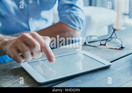 man reading emails and news on social media, close up of hands using digital tablet computer, banking online Stock Photo