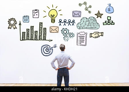 businessman looking at hand drawn business concept sketch Stock Photo