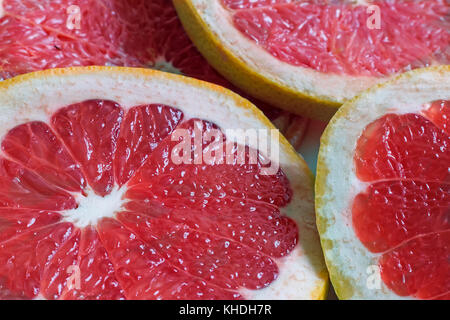 On the table cut fruit grapefruit. Presents closeup. The view from the top. Stock Photo