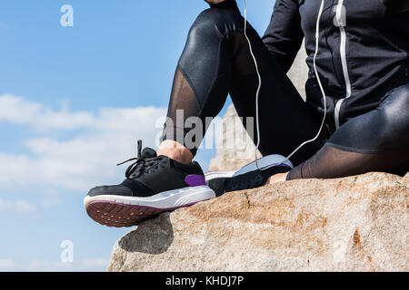 woman sitting on rocks Stock Photo