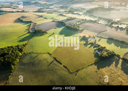 View over the Kent countryside from a balloon with long shadows and large fields. Taken early morning. Stock Photo