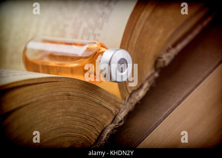 Vial On An Old Book Of Medicine, Conceptual Image Stock Photo