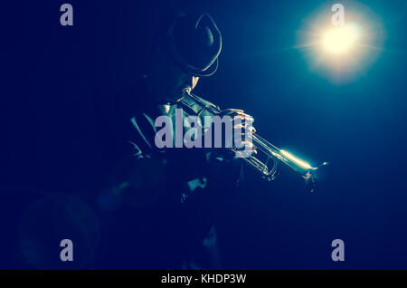 Musician playing the Trumpet with spot light and len flare on the stage Stock Photo