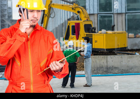 Asian engineers thinking and holding the note pad on construction site workers, industrial construction concept Stock Photo
