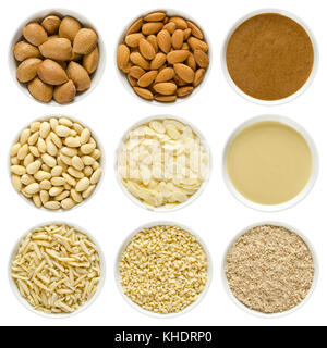 Almonds in white bowls. Whole nuts with shells, shelled, blanched, chopped, slivered, sliced, ground, brown and white almond butter. Prunus dulcis. Stock Photo