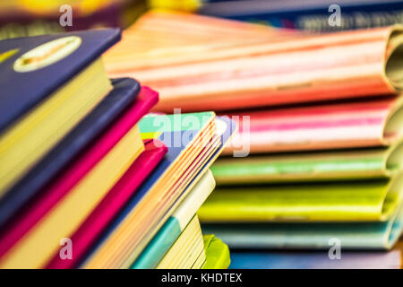 Many piles of very colored children books Stock Photo