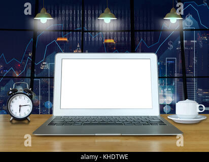 Workspace with computer laptop on the wood table with the windows which shown trading graph on the blurred photo of cityscape building background, tra Stock Photo