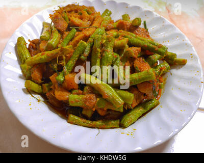 Stir Fried Bean Sprouts with hot and spicy curry , kaffir lime leaf and pork  in white plate Stock Photo