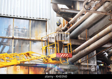 Working welder repairs pipes Stock Photo