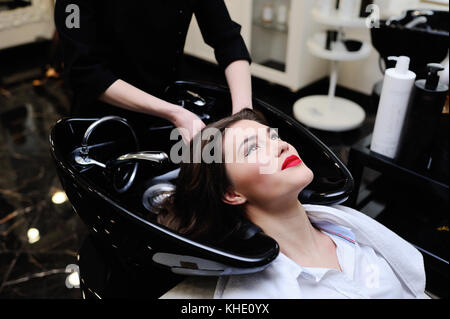 Beautiful girl washing her head in a beauty salon Stock Photo