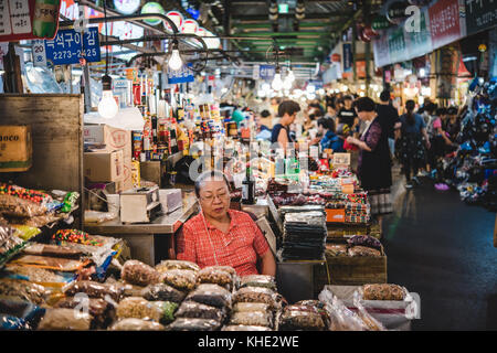 An older korean lady running her packaged foods stall in Kwangjang Market, Seoul 2017. Stock Photo