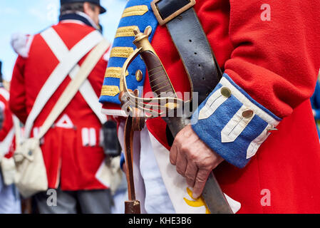 Scottish 19th century troops stand in formation with a military sword in foreground. Stock Photo
