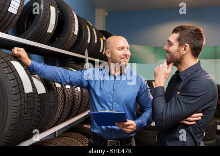 customer and salesman at car service or auto store Stock Photo