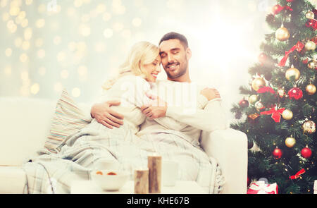 happy couple hugging over christmas tree Stock Photo