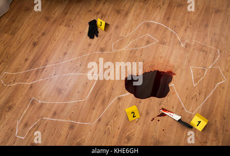 chalk outline and knife in blood at crime scene Stock Photo