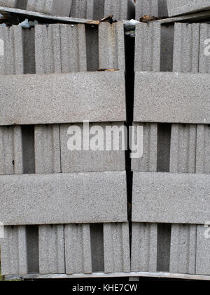 Cement blocks, breeze blocks, stacked. Building material, leaning precariously. Stock Photo