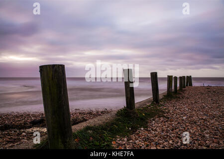 A simple image of groynes on the beach at Charmouth in Dorset. Stock Photo