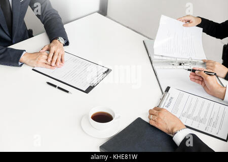 Businessman conducting an interview with businessman in an office. Stock Photo