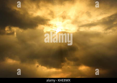 sun rays through cloudy sky, hope or opportunity concept, warm tone effect Stock Photo