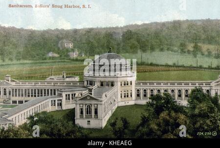 A postcard from a tinted photograph of a sanitarium, the center of the complex is a multistory building that is connected to other sections through long, narrow sections radiating outward, the grounds are fenced in and surrounded by farm land and forests, a few houses can be seen in the distance, Sailor's Snug Harbor, Staten Island, New York, 1900. From the New York Public Library. Stock Photo