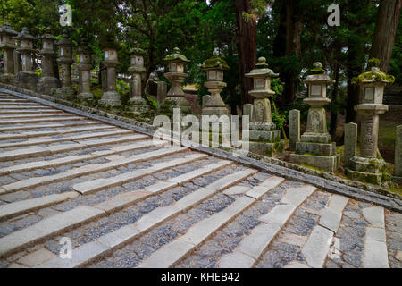 Nara - Japan, May 31, 2017: Row of many stone lanterns that lead up to the Kasuga Taisha shrine Stock Photo