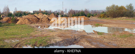 After heavy rain on the clay forest soil there are large puddles. Panoramiic collage from several outdoor photos Stock Photo