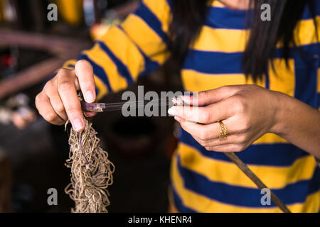 Woman making thread from lotus flower at Inle Lake, Myanmar.(Burma) Stock Photo