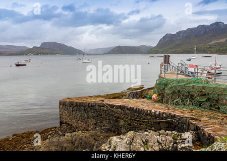 The original stone pier at Plockton, Ross & Cromarty, gives access to the village for small boats on Loch Carron, Scotland, UK Stock Photo