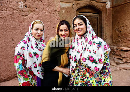 Young women with colorful chador, Abyaneh, Iran Stock Photo