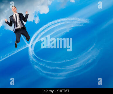 Happy businessman flies in blue sky Stock Photo