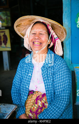 MINGUN,MYANMAR - MARC 6, 2017: Burmese old woman with hat and thanaka on their face in Mingun on March 6, 2017, Myanmar. Thanaka is a yellowish-white  Stock Photo