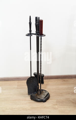 fireplace tools: shovel, brush, poker on the parquet floor Stock Photo