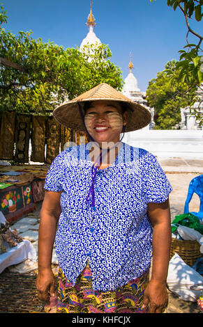 MANDALAY,MYANMAR - MARC 7, 2017: Unidentified Myanmar woman with thanaka on her smile face is happiness in Mandalay on March 7, 2017. Thanaka is a yel Stock Photo
