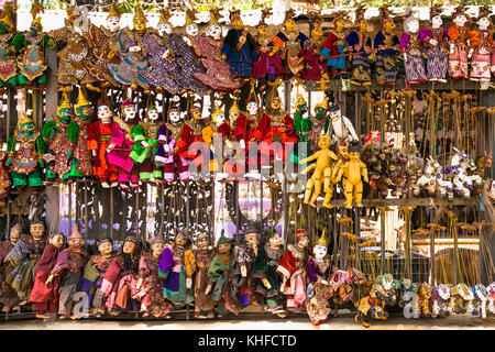 MANDALAY,MYANMAR - MARC 6, 2017: Hand Made Puppets, traditional handicrafts are sold at public street shop in Mandalay on March 6, 2017. Myanmar. (Bur Stock Photo