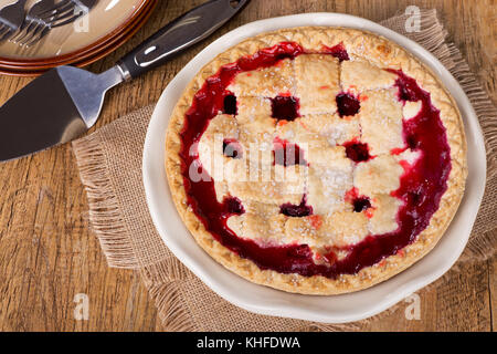 Top view of a whole cherry pie on a wooden table Stock Photo