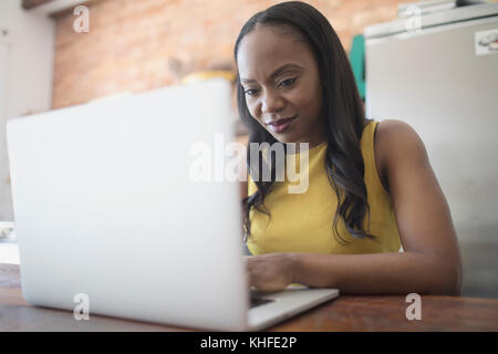 Businesswoman working on her laptop from home Stock Photo