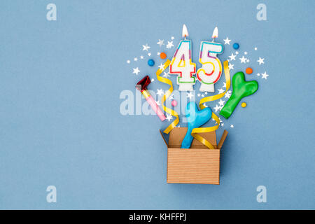 Number 45 celebration present background. Gift box exploding with party decorations Stock Photo