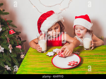 Two girls near Christmas tree Stock Photo