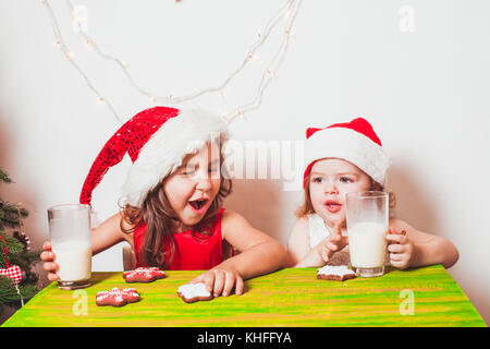 Two girls near Christmas tree Stock Photo