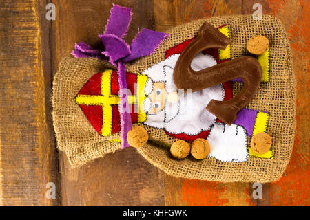 Traditional Dutch Saint Nicolas celebration with presents for children in December, Saint Nicolas  gift bag and chocolate letters close up Stock Photo